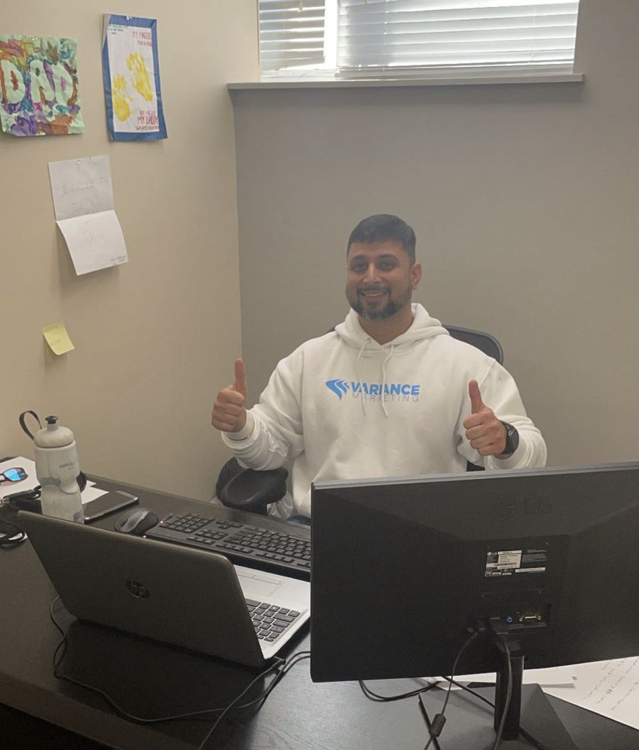 A Variance Marketing team member at his desk, thumbs up